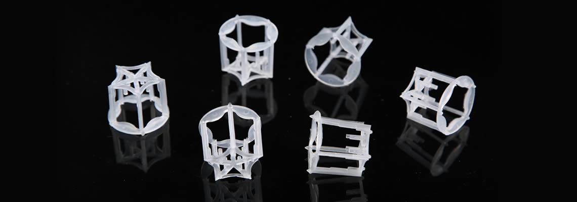 Six plastic pentagon rings lying on the black glass in different condition.